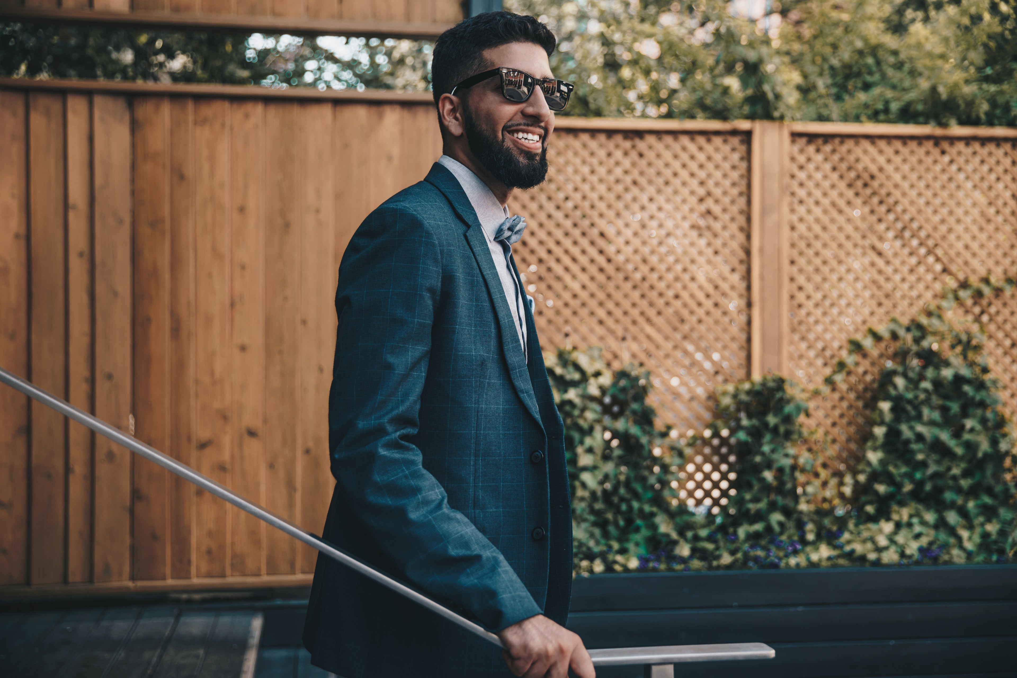 A sharp-looking man smiling in a suit.